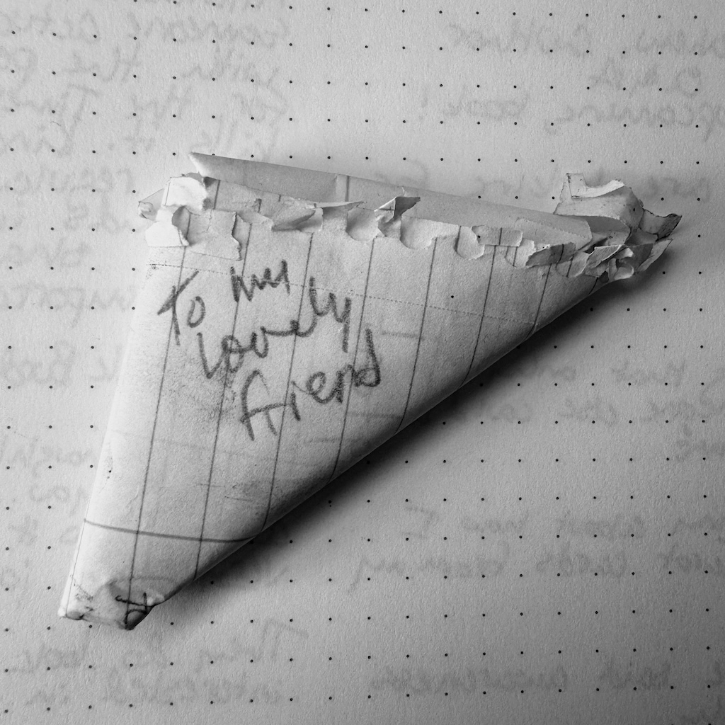 Note on looseleaf paper folded in the 'Chinese football' shape with 'to my lovely friend' written on the outside